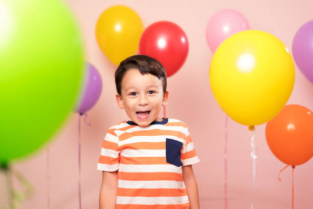 istock Cute child among colorful balloons. 871262662