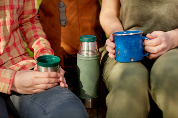 istock Two women drinking a mug of hot coffee together 871263096