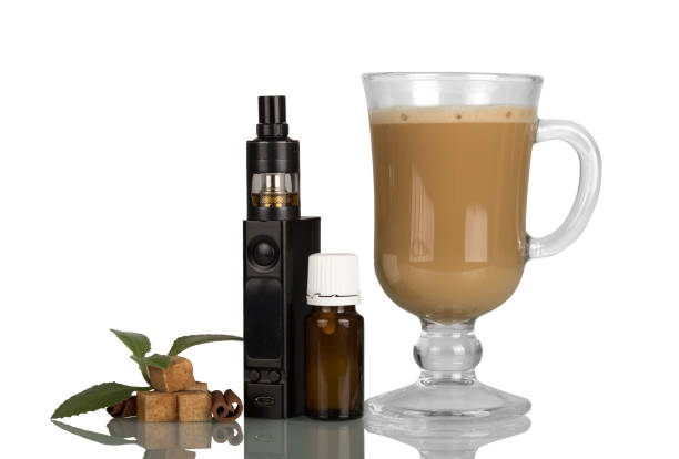 istock Cappuccino cup and electronic cigarette with aromatic liquid isolated on white 871263714