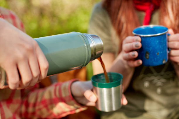 istock Two women enjoying hot coffee on a hike 871263860