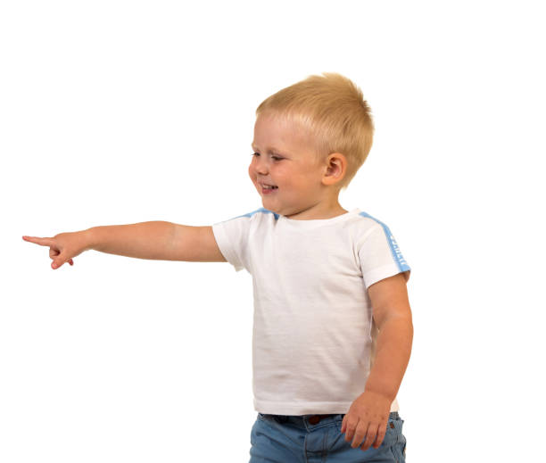 istock Little smiling boy showing finger on banner, isolated on white 871263904
