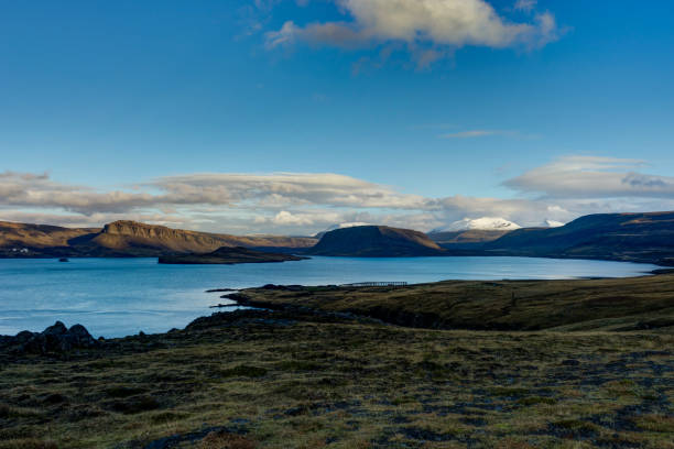 istock Iceland view over water towards mountains with blue sky and clou 871268372