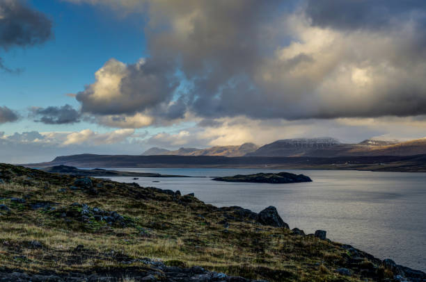 istock Iceland view over water towards mountains with blue sky and clou 871269004