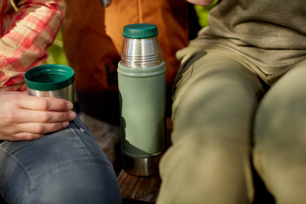 istock Woman drinking a mug of coffee from a flask 871269810
