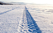 Tyre tracks in the snow on lake Baikal ice surface