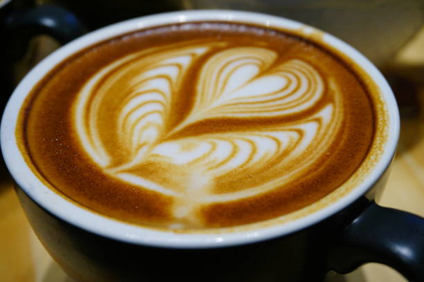 istock Cup of cafe' latte with coffee beans and cinnamon sticks 871273764