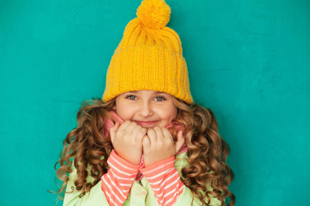 istock eautiful little lady wearing yellow woolen cap and scarf 871273850