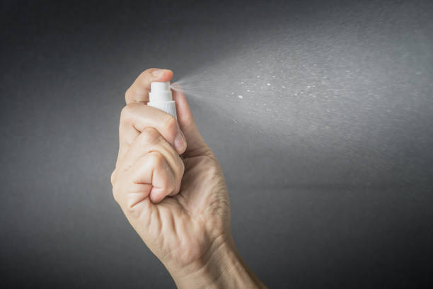 istock hand hold small spray bottle and spraying 871274598