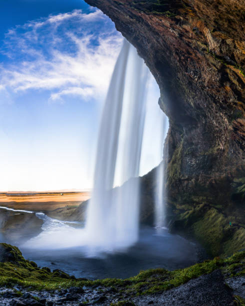 istock Cave behind Seljalandsfoss Waterfall in Iceland with long Exposu 871274866