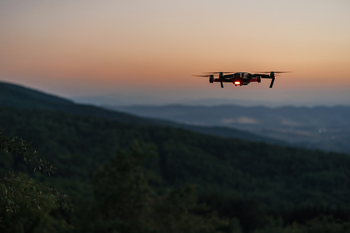 Drone flying over a mountain at dusk