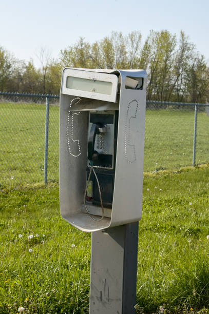 istock Outdoor telephone booth in a grassy field 871275940