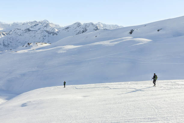 istock Two snowshoe hikers in alpine winter mountains. Bavaria, Germany. 871280360