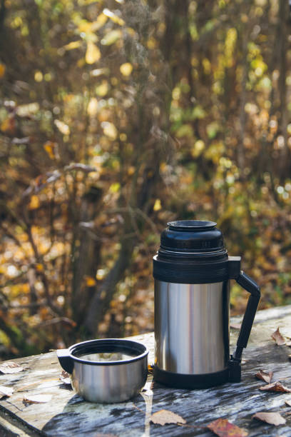 istock Hot tea and a thermos on the table in the fall 871281318