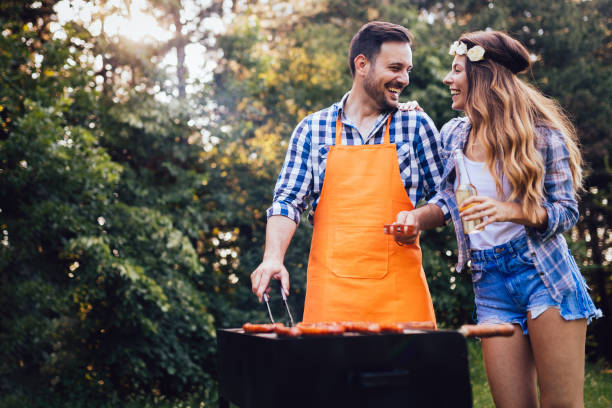 Beautiful woman and handsome man having barbecue