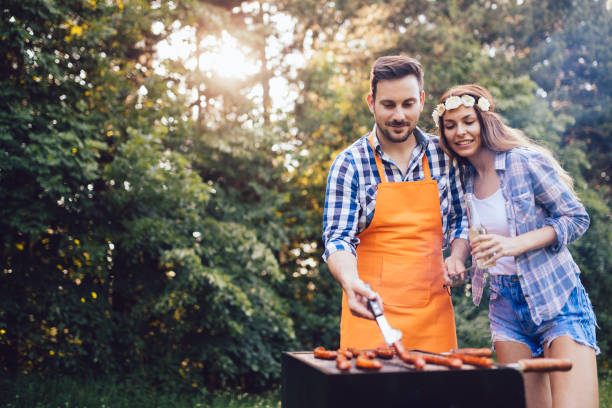 istock Beautiful woman and handsome man having barbecue 871284928