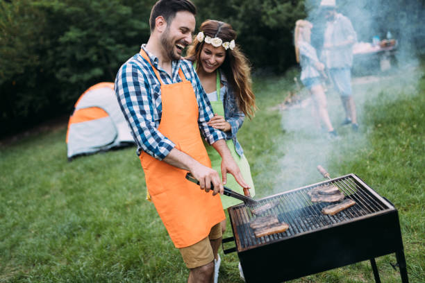 istock Beautiful woman and handsome man having barbecue 871285570