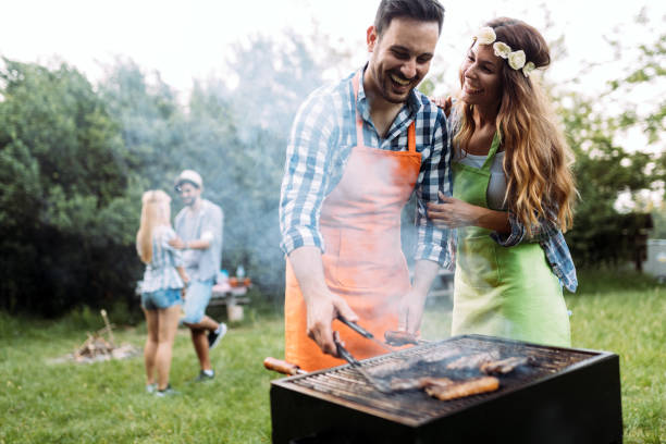 istock Beautiful woman and handsome man having barbecue 871285618