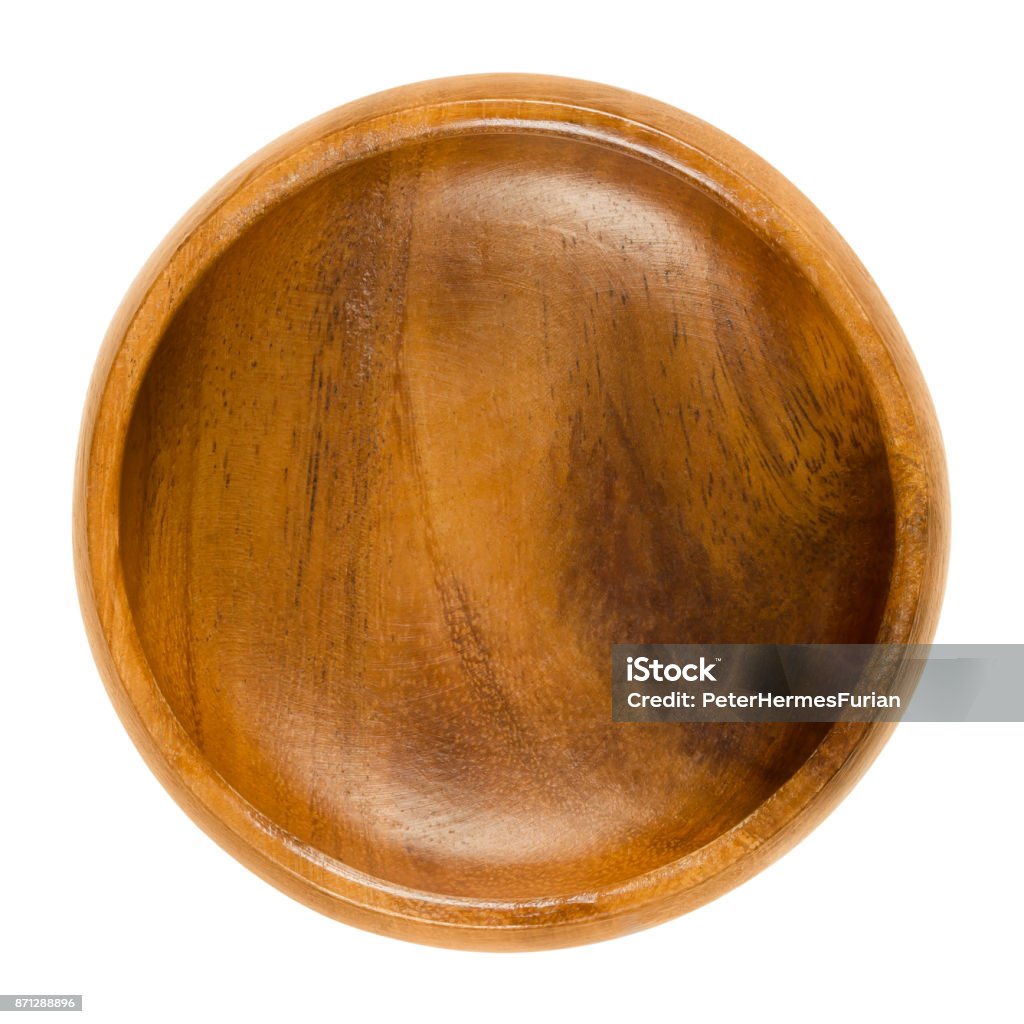 Empty wooden bowl over white Empty wooden bowl. Small brown bowl with wood grain in simple design. Round open-top container for storing food and non-food items. Isolated macro photo close up from above on white background. Bowl Stock Photo