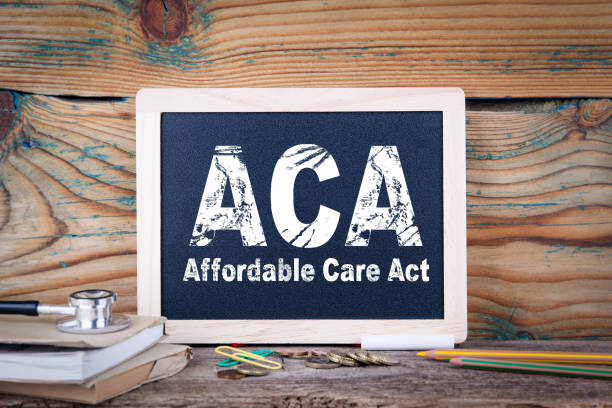 istock aca, affordable care act. Chalkboard on a wooden background 871293090