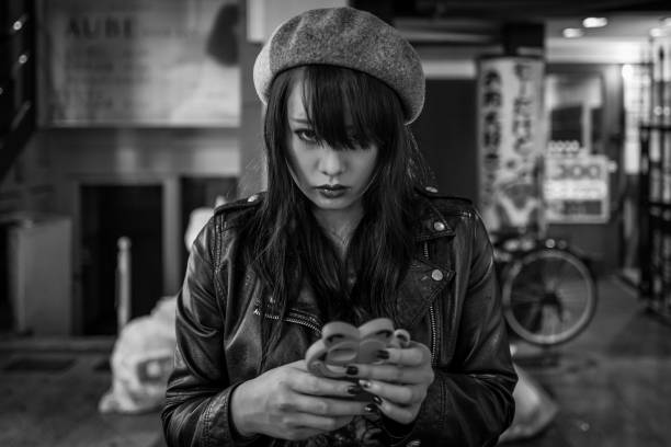 Kumamoto, Japan - May 12: Young attractive girl looks at camera in shopping district on May 12, 2017 in Kumamoto, Japan