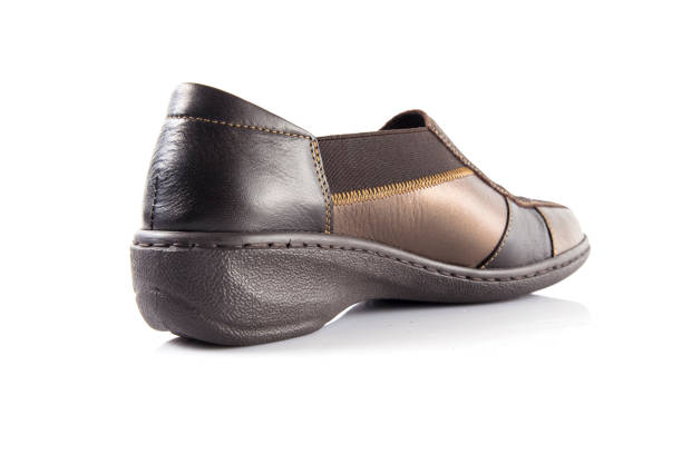 istock Female brown leather shoe on white background 871296376
