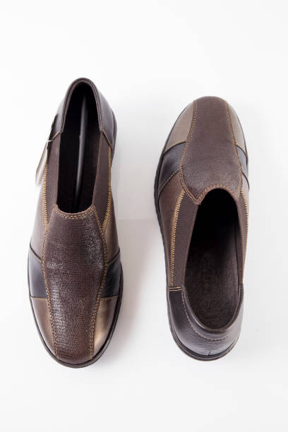 istock Female brown leather shoe on white background 871297296