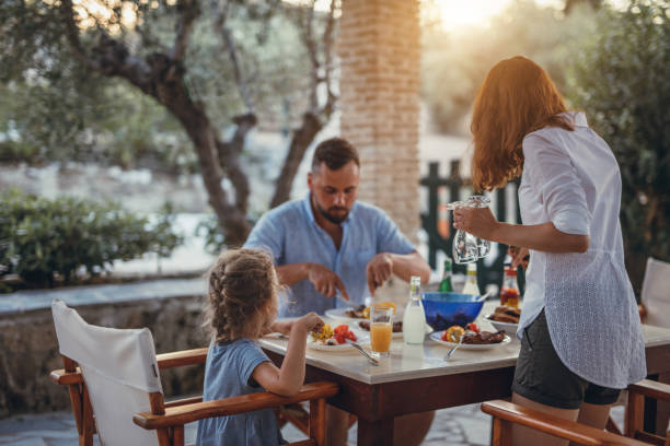 Father and dauther having mediterranean dinner on a terrace