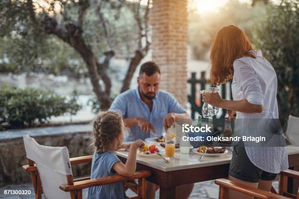 Father And Dauther Having Mediterranean Dinner On A Terrace Stock Photo - Download Image Now