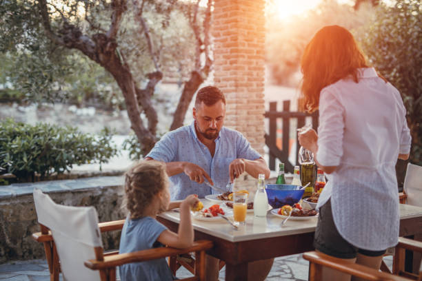 istock Father and dauther having mediterranean dinner on a terrace 871300372