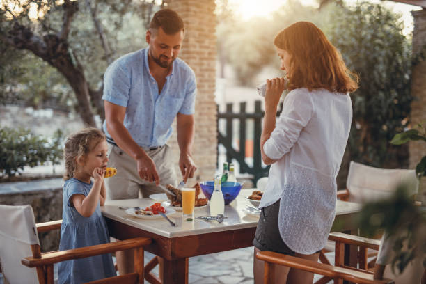 istock Father and dauther having mediterranean dinner on a terrace 871300518