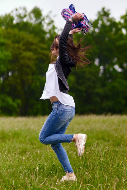 istock Woman jumping for joy 871304386