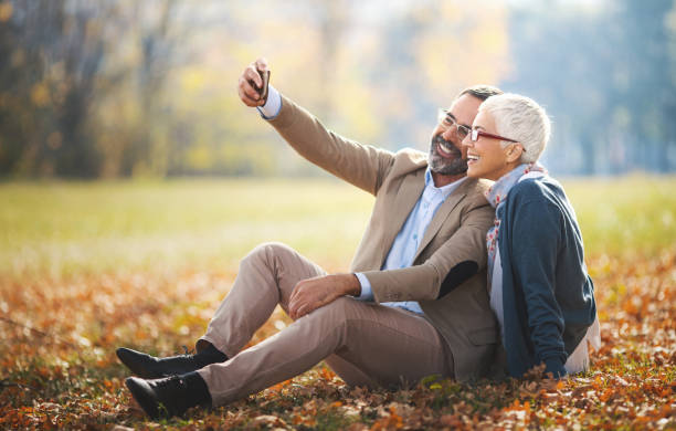 istock Mid aged couple in a park 871304654
