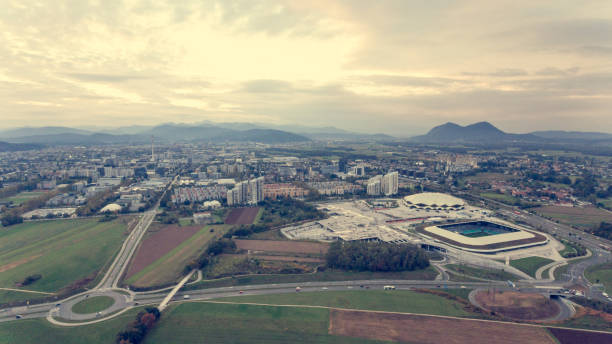 Aerial view of a roundabout connecting different roads. Sport stadium near by.