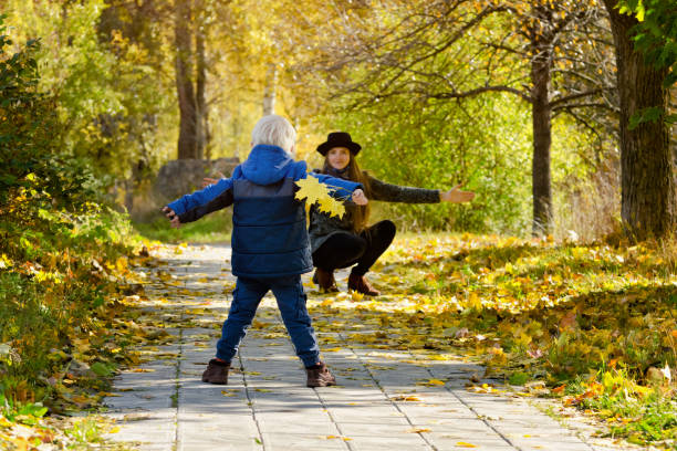 istock Mom catches running son. Autumn forest 871308600