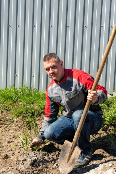 istock Farmer with rakes in the suburban area 871308988