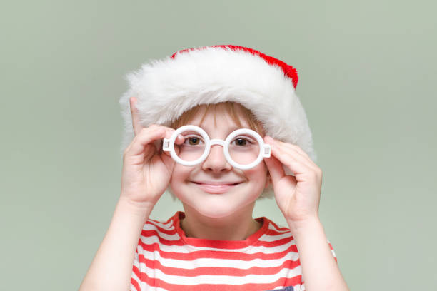 istock Boy is wearing Santa's glasses and hat. Portrait 871316244