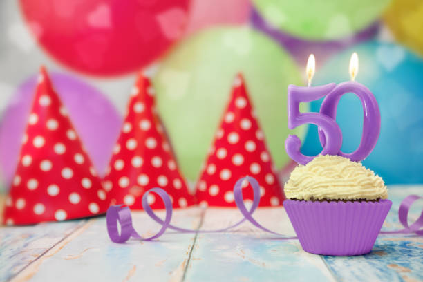 istock 50 anniversary birthday cupcake with candle 871316488
