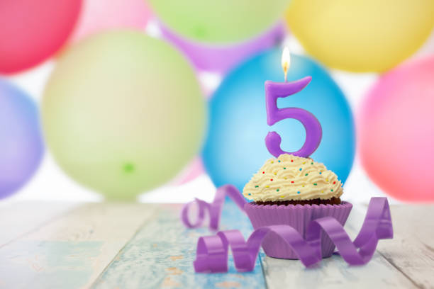 istock Birthday cupcake for fifth birthday and balloons 871319470