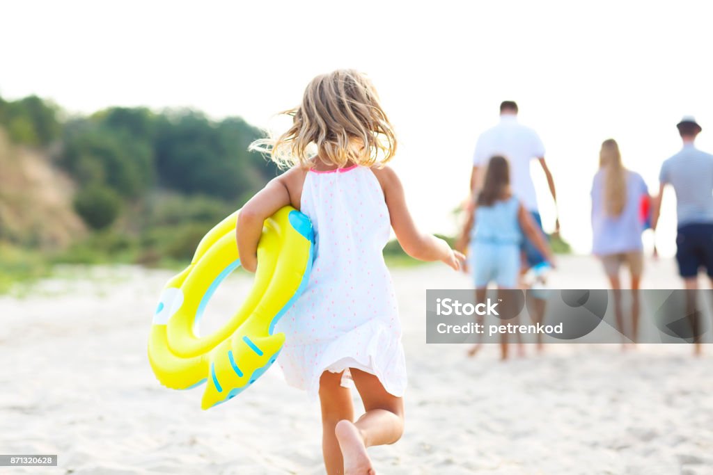 Young blonde girl running on the beech Young blonde girl running on the beech. Summer vacation and travel concept Beach Stock Photo