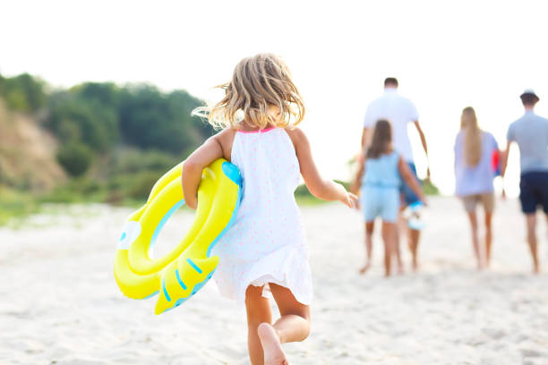 young blonde girl running on the beech - group of people women beach community imagens e fotografias de stock