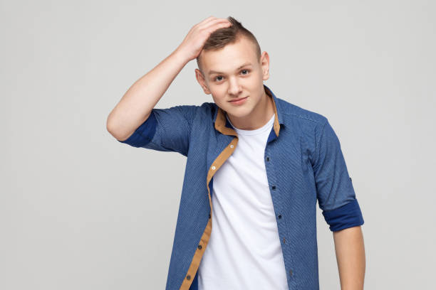 istock Hmm let my think. Quizzical boy looking down and thinking. 871323884