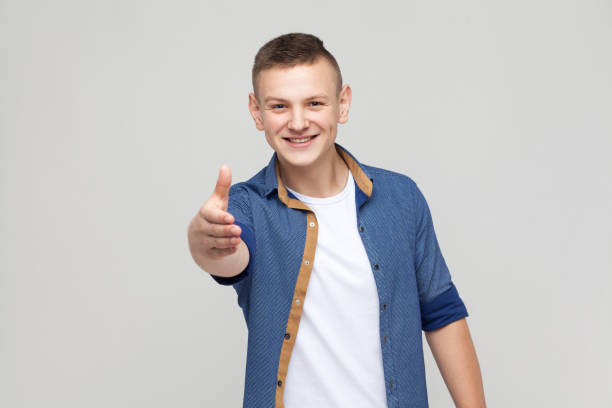 istock Handshake. Boy need a friendship. Showing hand at camera 871323890