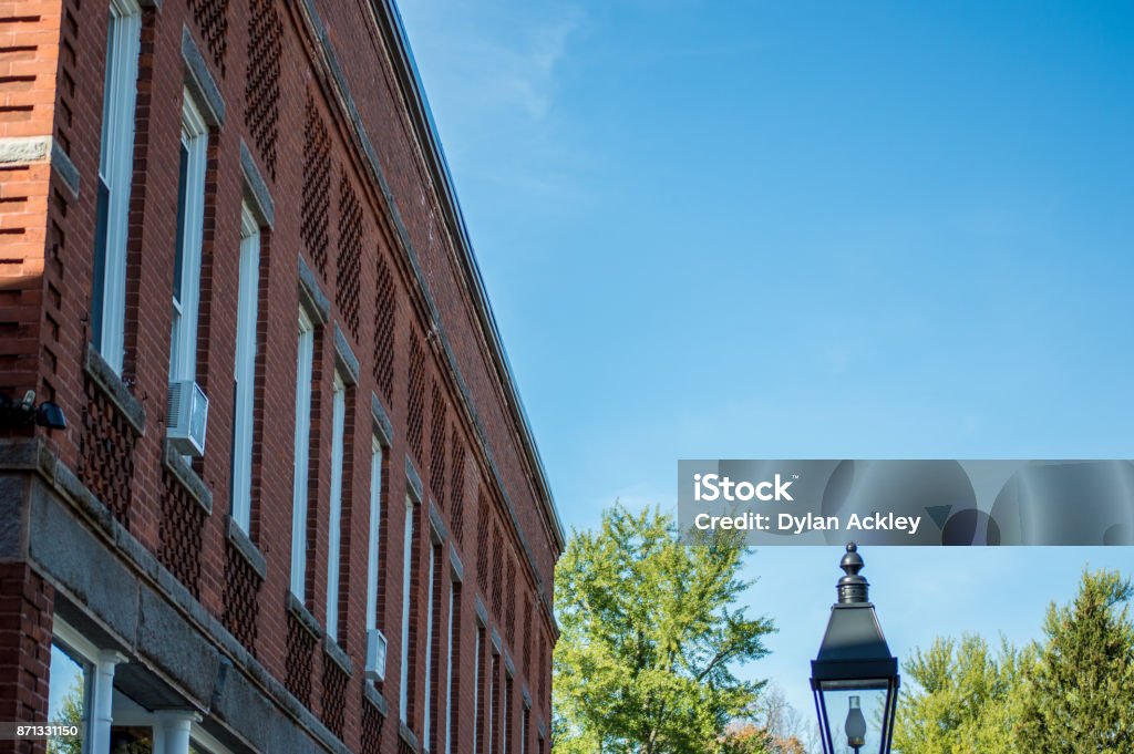 Brick Buildings Against the Sky Old, red brick buildings contrasted against a beautiful, blue sky. These can be found in historic Litchfield, Connecticut-New England. Connecticut Stock Photo