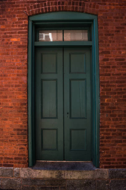 istock Old Green Door on Red Bricks 871331158