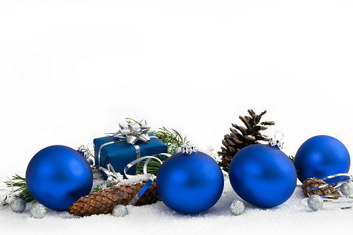 Christmas lower decoration with balls, cones and gift on white background.
