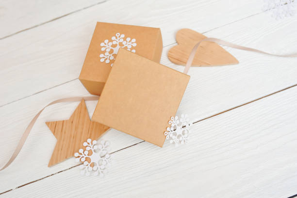 istock mockup Christmas gift boxes with Christmas decorations. Greeting card with a Christmas present, wooden star and Christmas tree on a white background 871335330