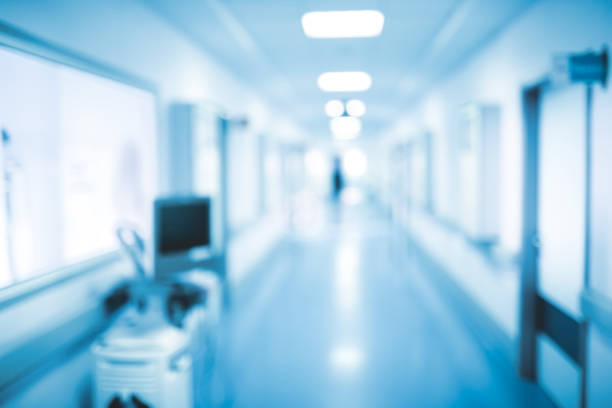 istock Dark silhouette walking on the hospital hall, unfocused background 871335534