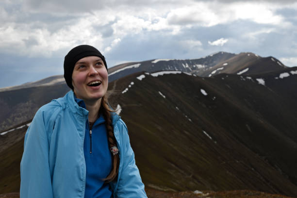 istock Happy girl on the mountain range background 871336434