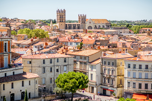 Aerial cityscape view on the old town with cathedral in Montpellier city during the sunny weather in Occitanie region of France