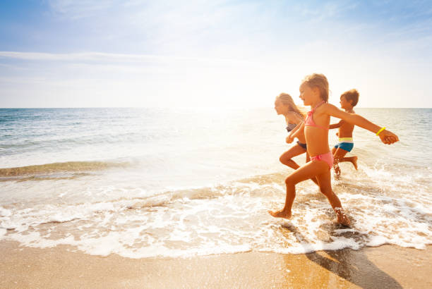 istock Cute kids having fun on sandy beach in summer 871342736